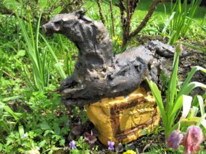 Leaping Horse, stylised ceramic sculpture in gold/brown with orange decorated stand