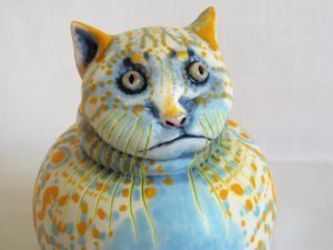 Porcelain cat sculpture with coloured decoration by Ellen Cooper